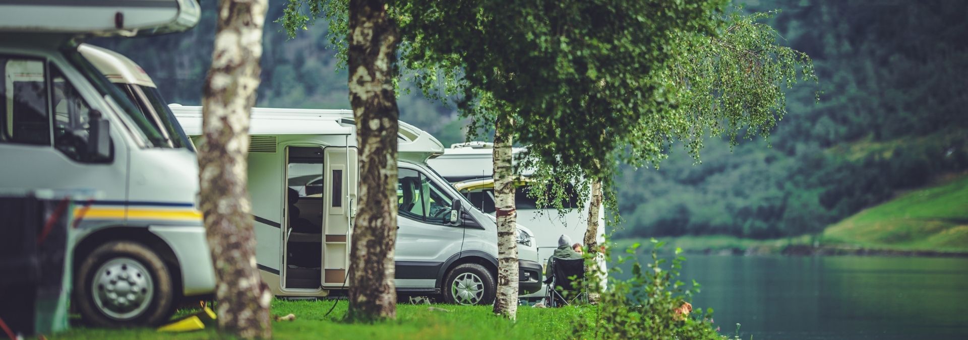 RVs in a campground hear the water